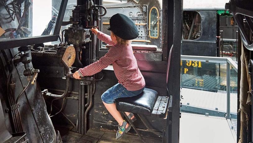 Boy with conductor hat at the railway museum