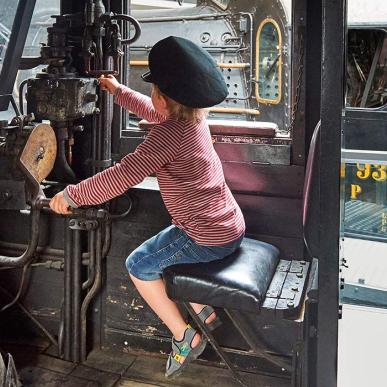 Boy with conductor hat at the railway museum